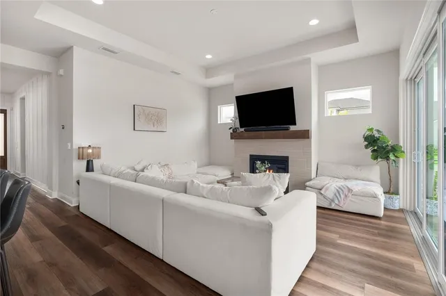 a living room with furniture a flat screen tv and a fireplace