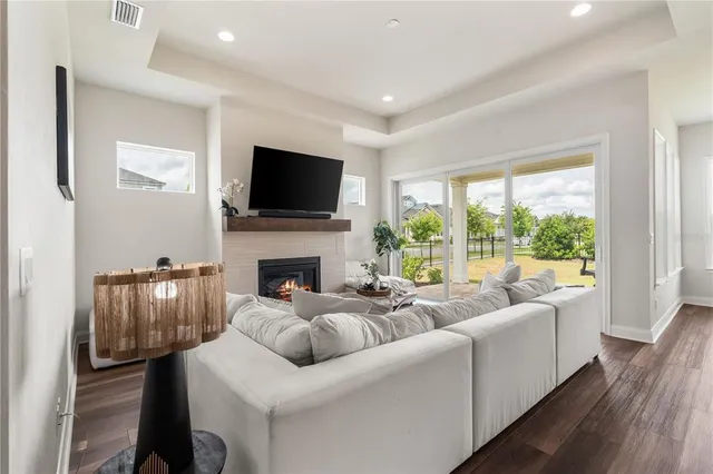 a living room with furniture fireplace and a flat screen tv