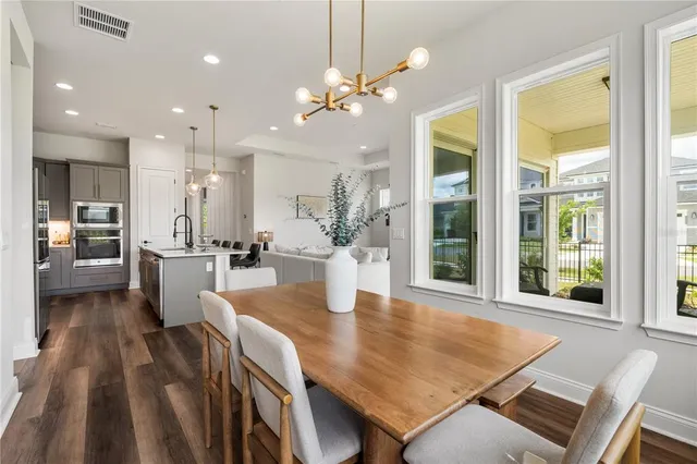 a view of a dining room with furniture and a chandelier