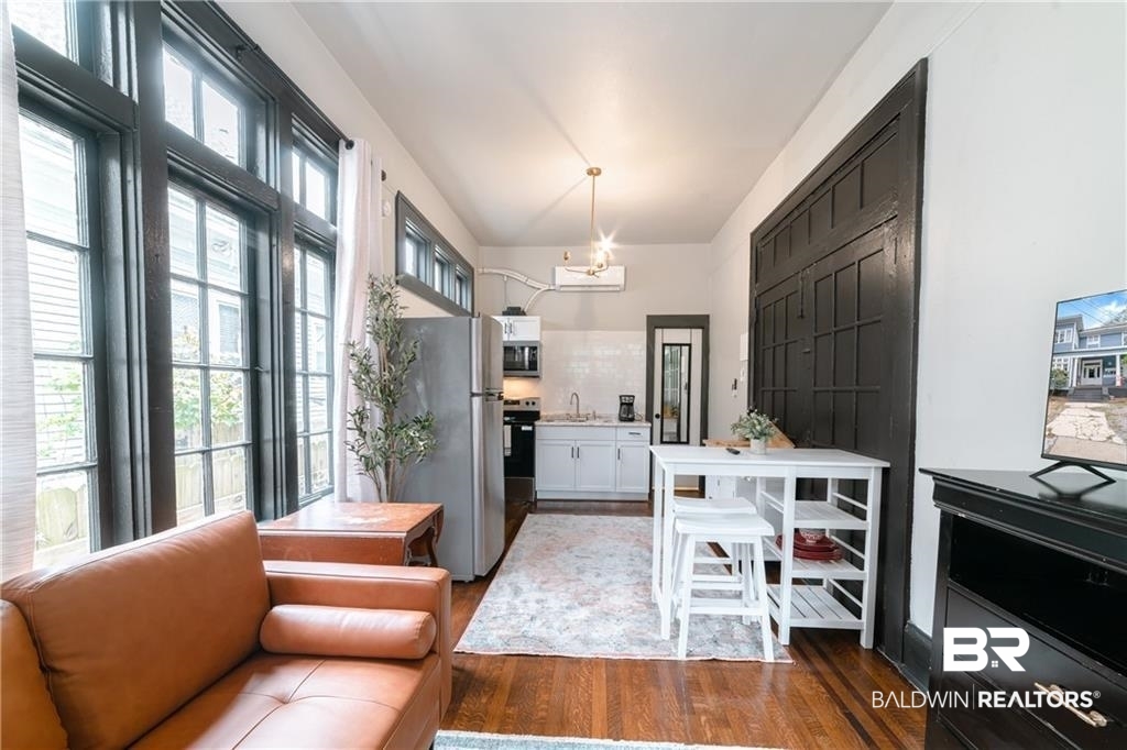 207 Michigan Avenue Mobile, AL 36604 - Photo 12 of 31 Dining room with a chandelier and wood finished floors
