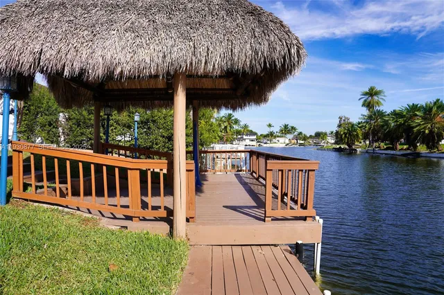 a kitchen with a dining table chairs and refrigerator