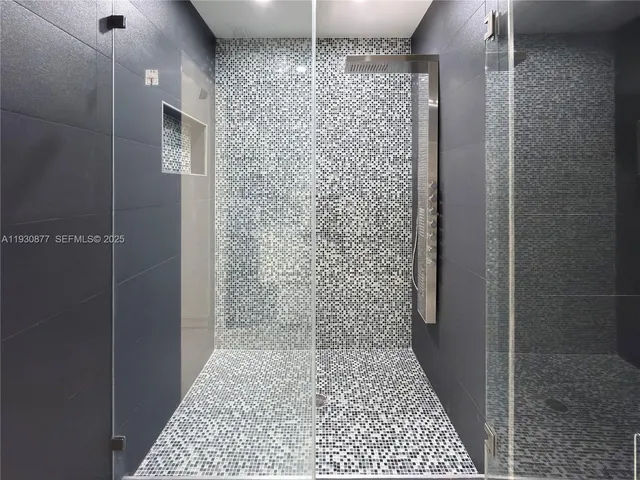 a bathroom with a glass door shower