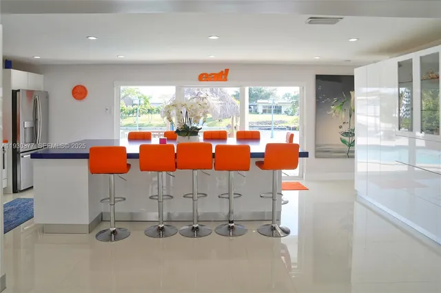 a kitchen with stainless steel appliances granite countertop a sink refrigerator and cabinets