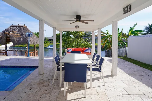 a view of a patio with chairs next to a yard