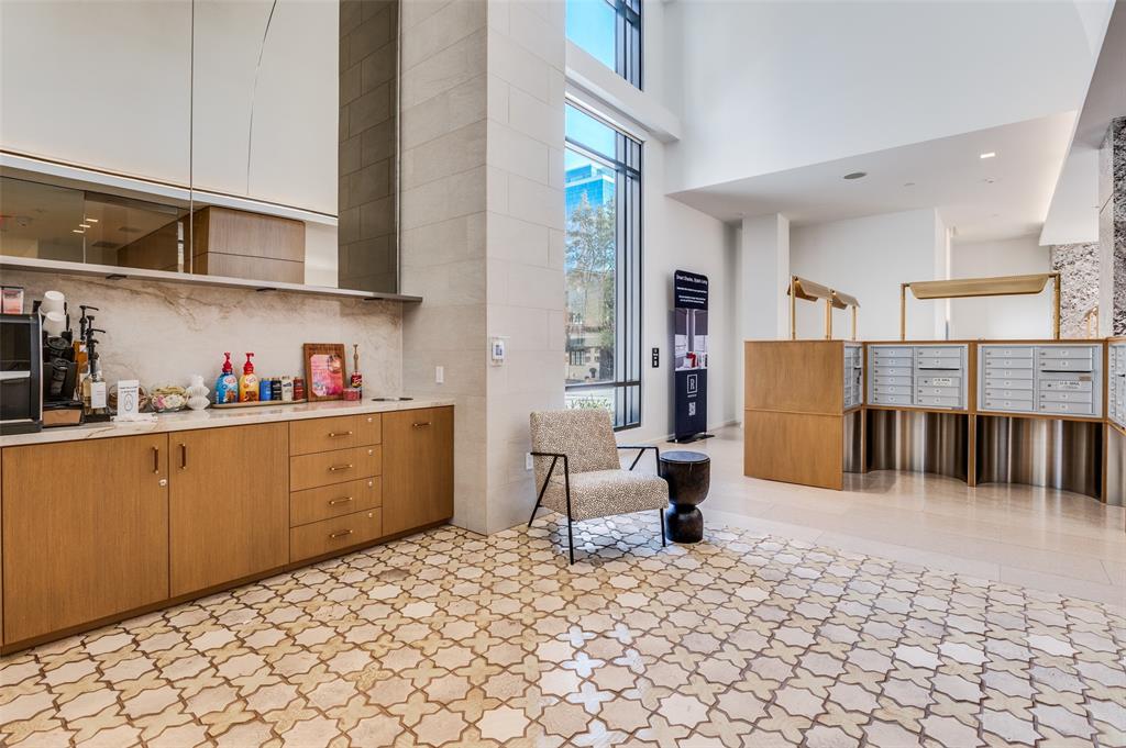 3003 Maple Avenue, Unit 2220 Dallas, TX 75201 - Photo 36 of 40 a kitchen with stainless steel appliances kitchen island granite countertop a refrigerator and a sink