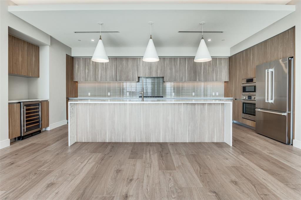 3003 Maple Avenue, Unit 2220 Dallas, TX 75201 - Photo 4 of 40 a large kitchen with stainless steel appliances a large counter top a sink a stove and a refrigerator