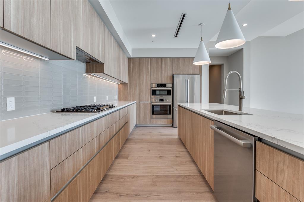 3003 Maple Avenue, Unit 2220 Dallas, TX 75201 - Photo 7 of 40 a kitchen with stainless steel appliances a sink and a stove