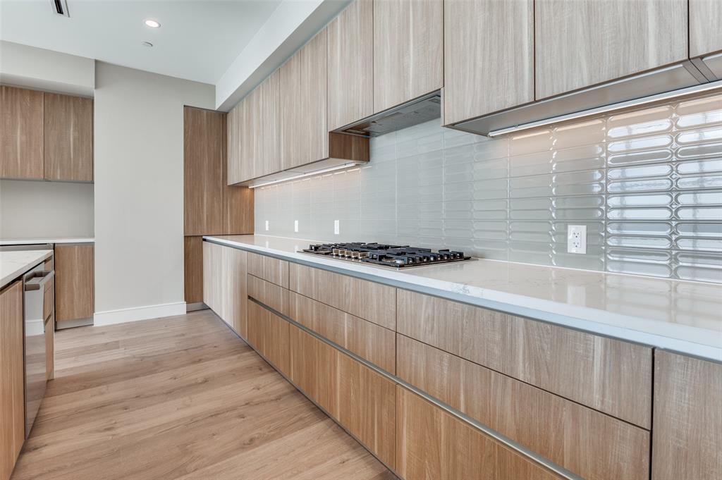 3003 Maple Avenue, Unit 2220 Dallas, TX 75201 - Photo 8 of 40 a kitchen with granite countertop cabinets and stove top oven