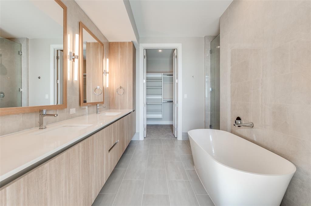 3003 Maple Avenue, Unit 2220 Dallas, TX 75201 - Photo 10 of 40 a spacious bathroom with a double vanity sink and a large mirror