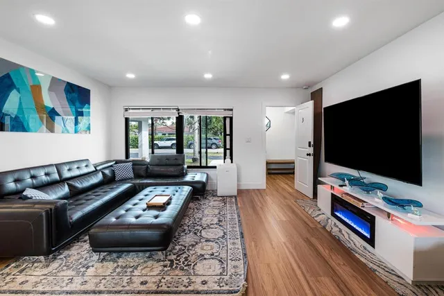 a kitchen that has a lot of cabinets and stainless steel appliances