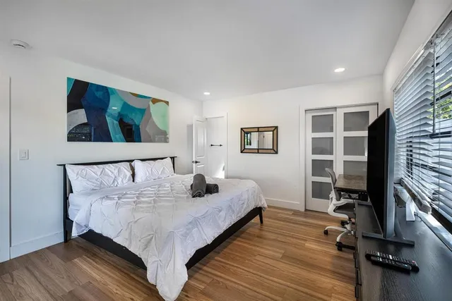 a view of a hallway with couch and closet with wooden floor
