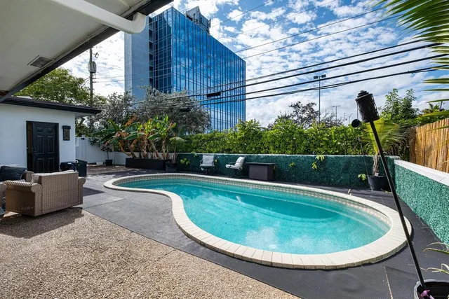 a view of a patio with table and chairs and wooden floor