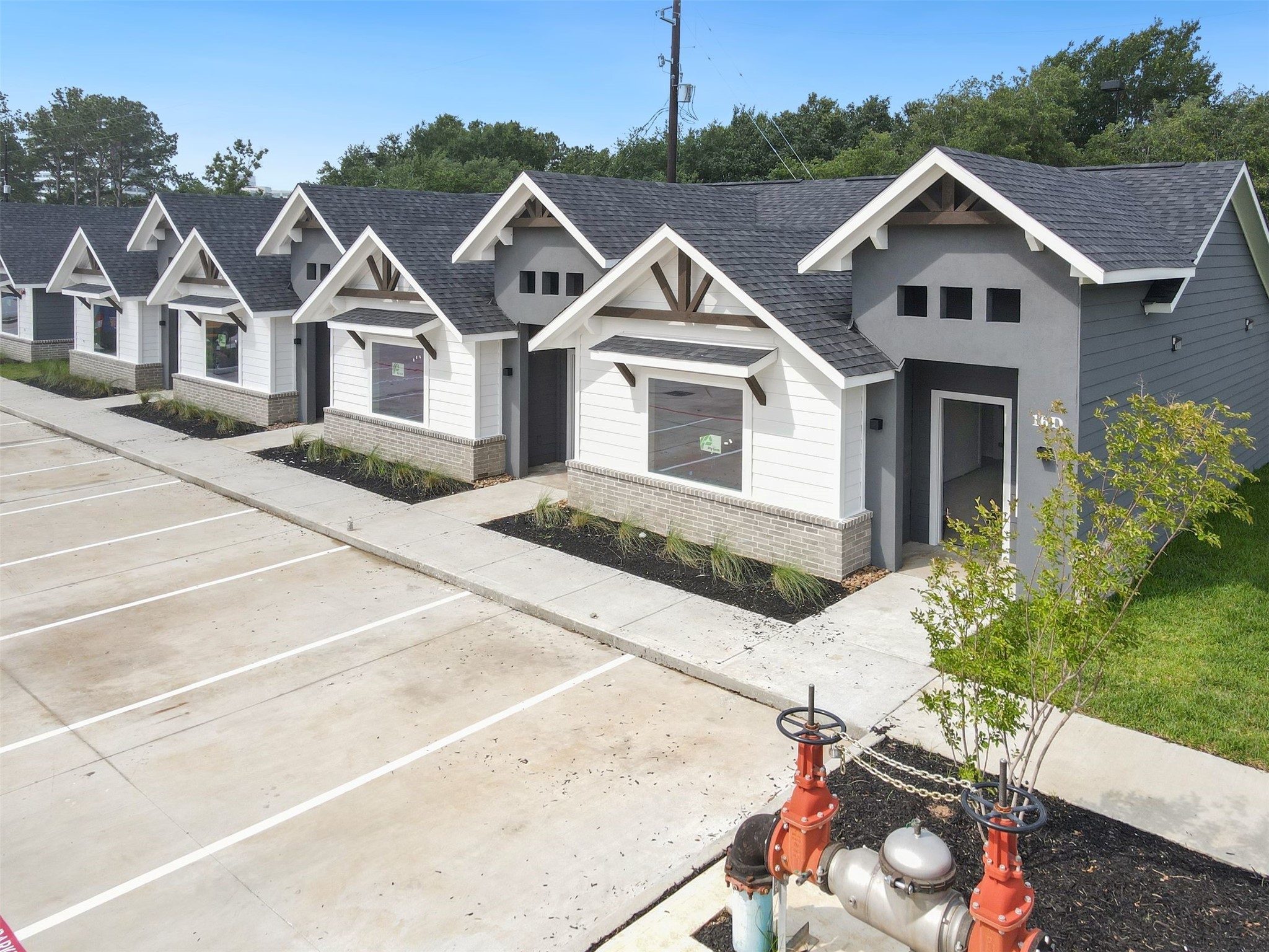 10317 Lake Road, Unit 13B Houston, TX 77070 - Photo 1 of 28 a front view of a house with a yard