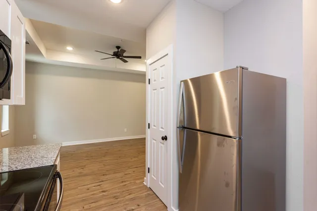 a view of a kitchen with a sink dishwasher and a refrigerator