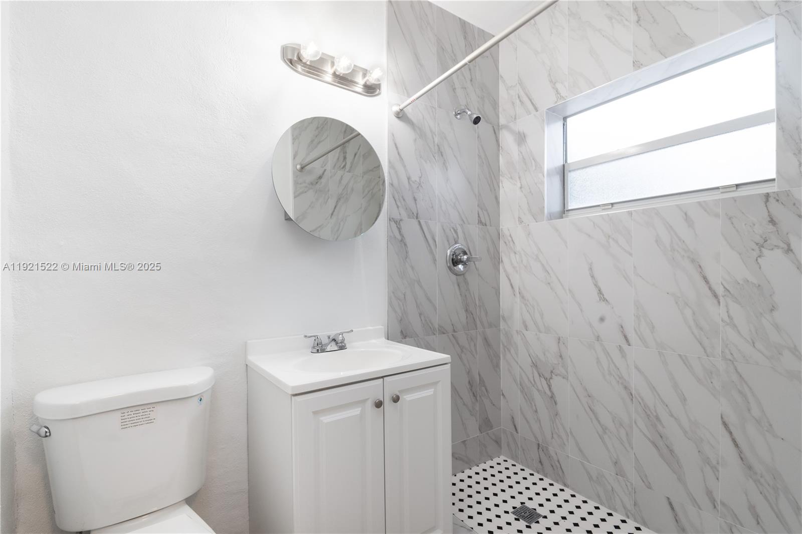 1450 Southwest 6th Street, Unit 1 Miami, FL 33135 - Photo 3 of 7 a bathroom with a sink a toilet and shower