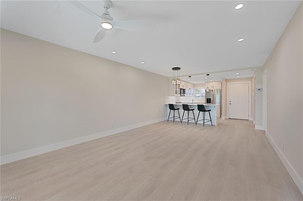 9 High Point Circle North, Unit 108 Naples, FL 34103 - Photo 8 of 17 Lanai to Kitchen