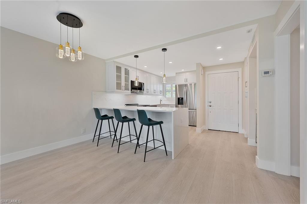 9 High Point Circle North, Unit 108 Naples, FL 34103 - Photo 9 of 17 Dining Area to Kitchen