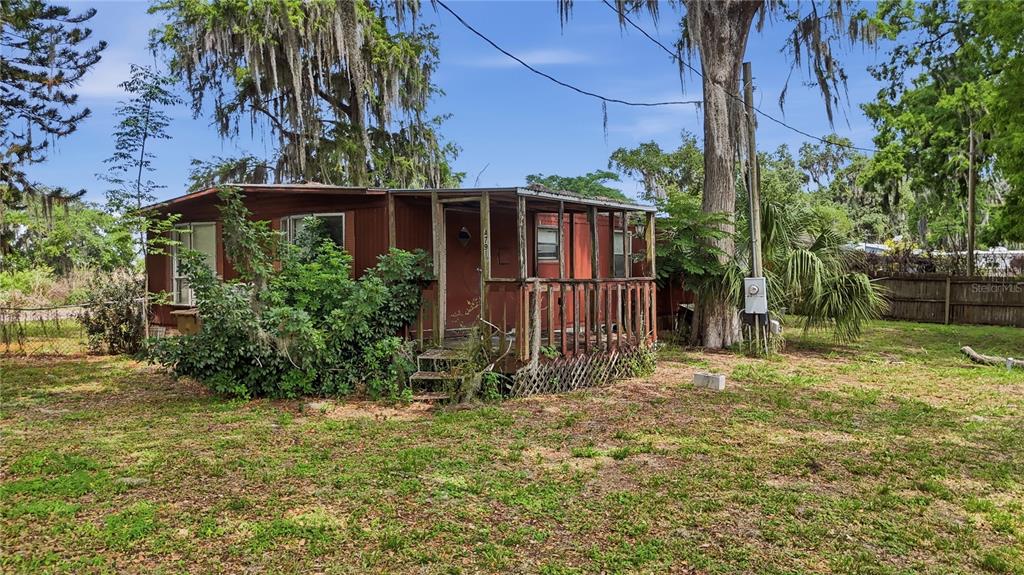 4791 Sunset Road St. Cloud, FL 34771 - Photo 2 of 7 a view of a backyard with plants and large trees