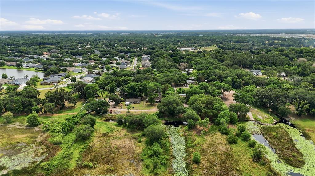 4791 Sunset Road St. Cloud, FL 34771 - Photo 7 of 7 an aerial view of residential houses with outdoor space and trees