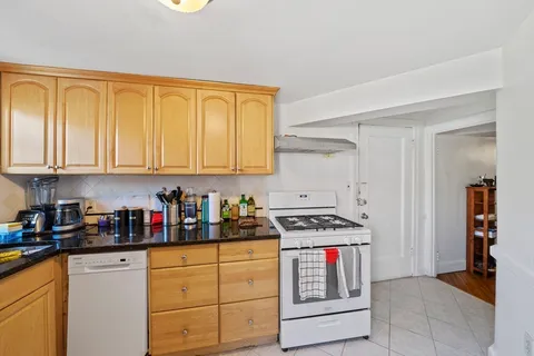 a kitchen with stainless steel appliances granite countertop a stove and a refrigerator