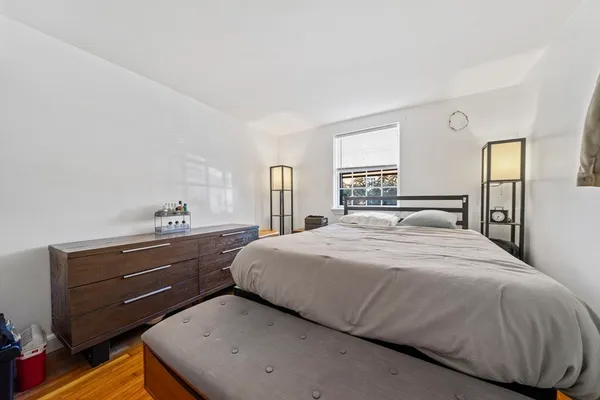 a bedroom with a bed and window