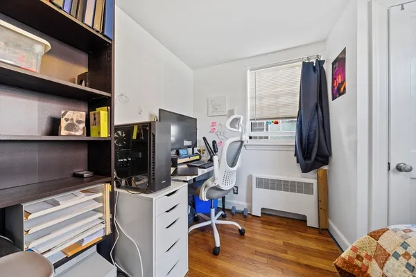 a view of a livingroom with workspace and a window