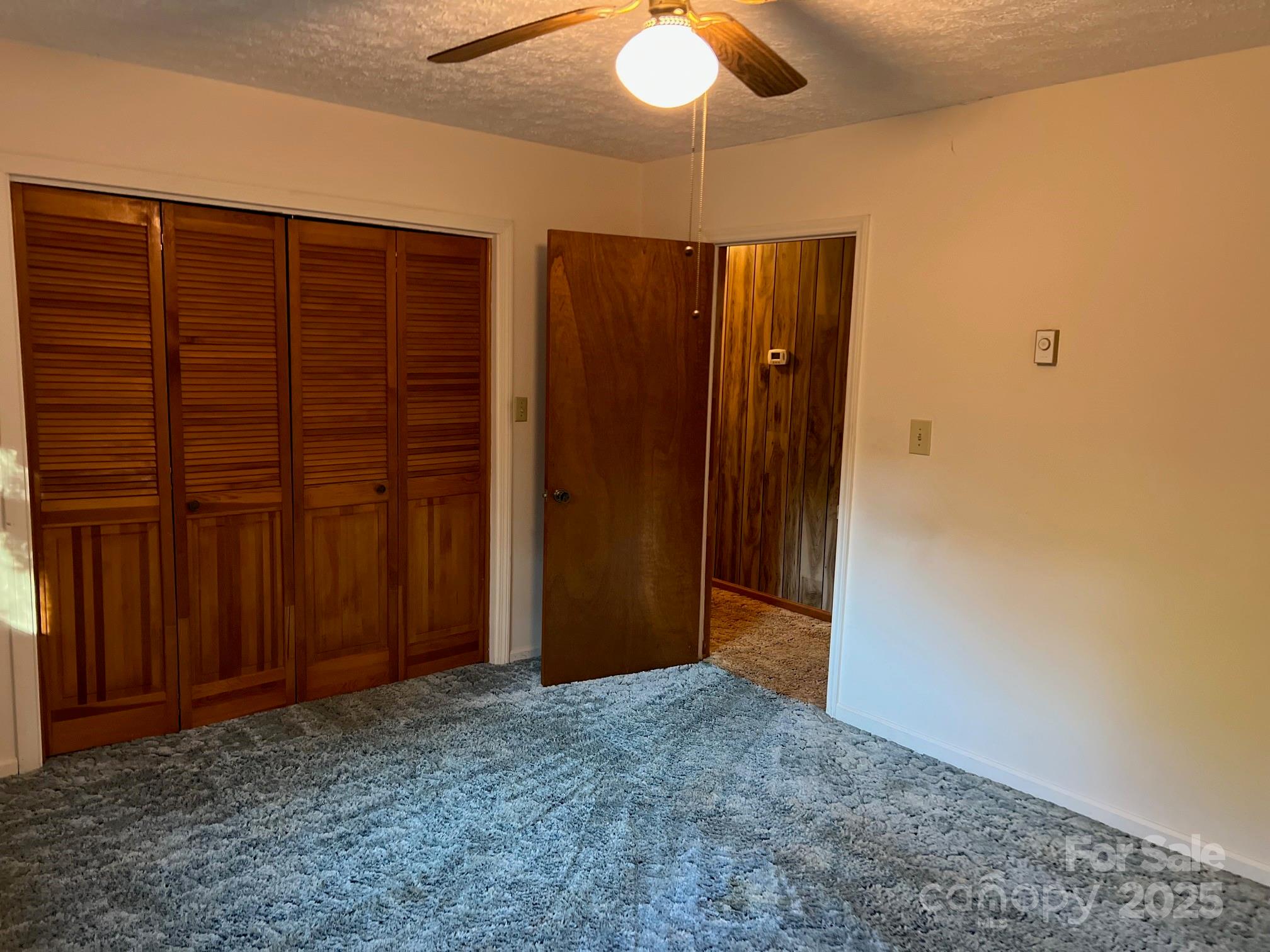 2819 Playmore Beach Road Morganton, NC 28655 - Photo 17 of 30 en empty room with a ceiling fan