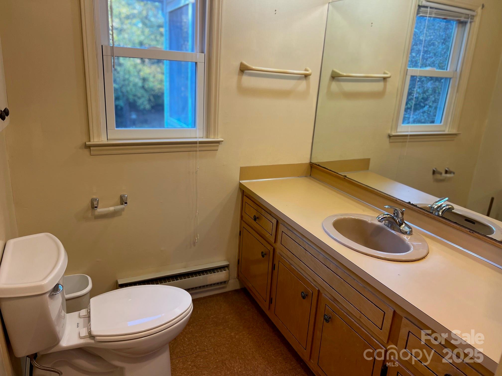 2819 Playmore Beach Road Morganton, NC 28655 - Photo 19 of 30 a bathroom with a granite countertop toilet sink and mirror