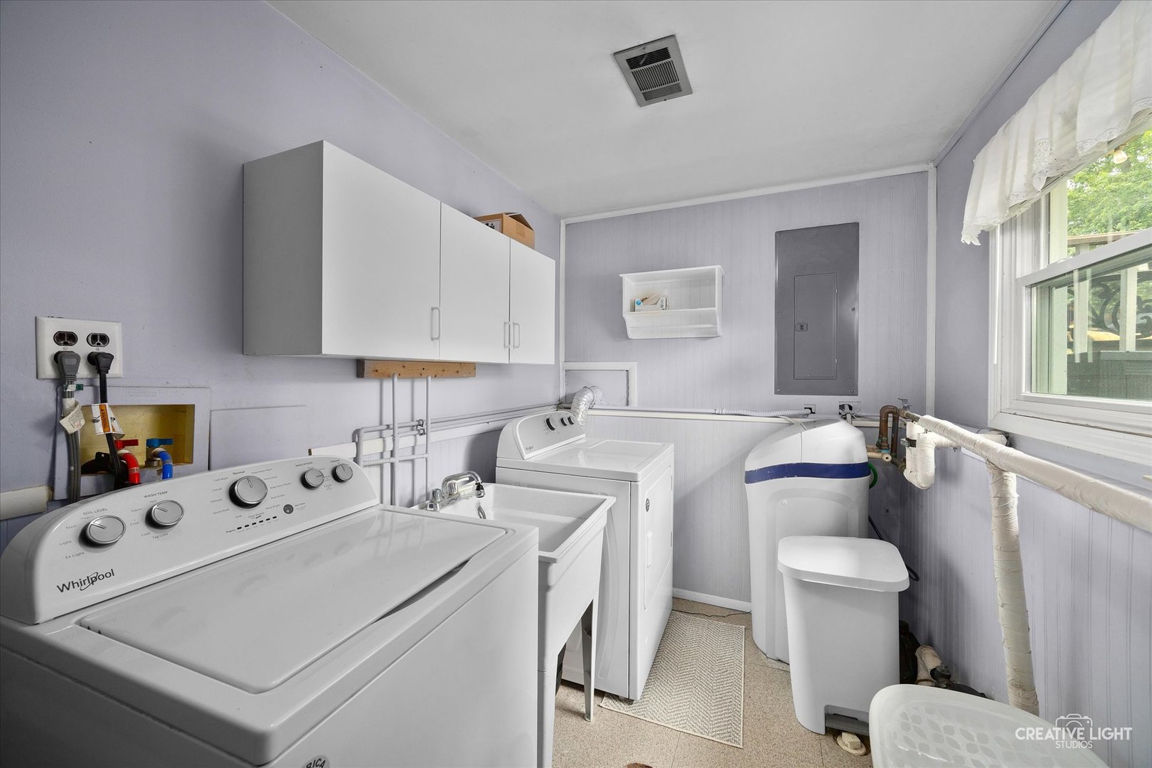 124 Fairview Drive St. Charles, IL 60174 - Photo 24 of 37 a utility room with cabinets washer and dryer