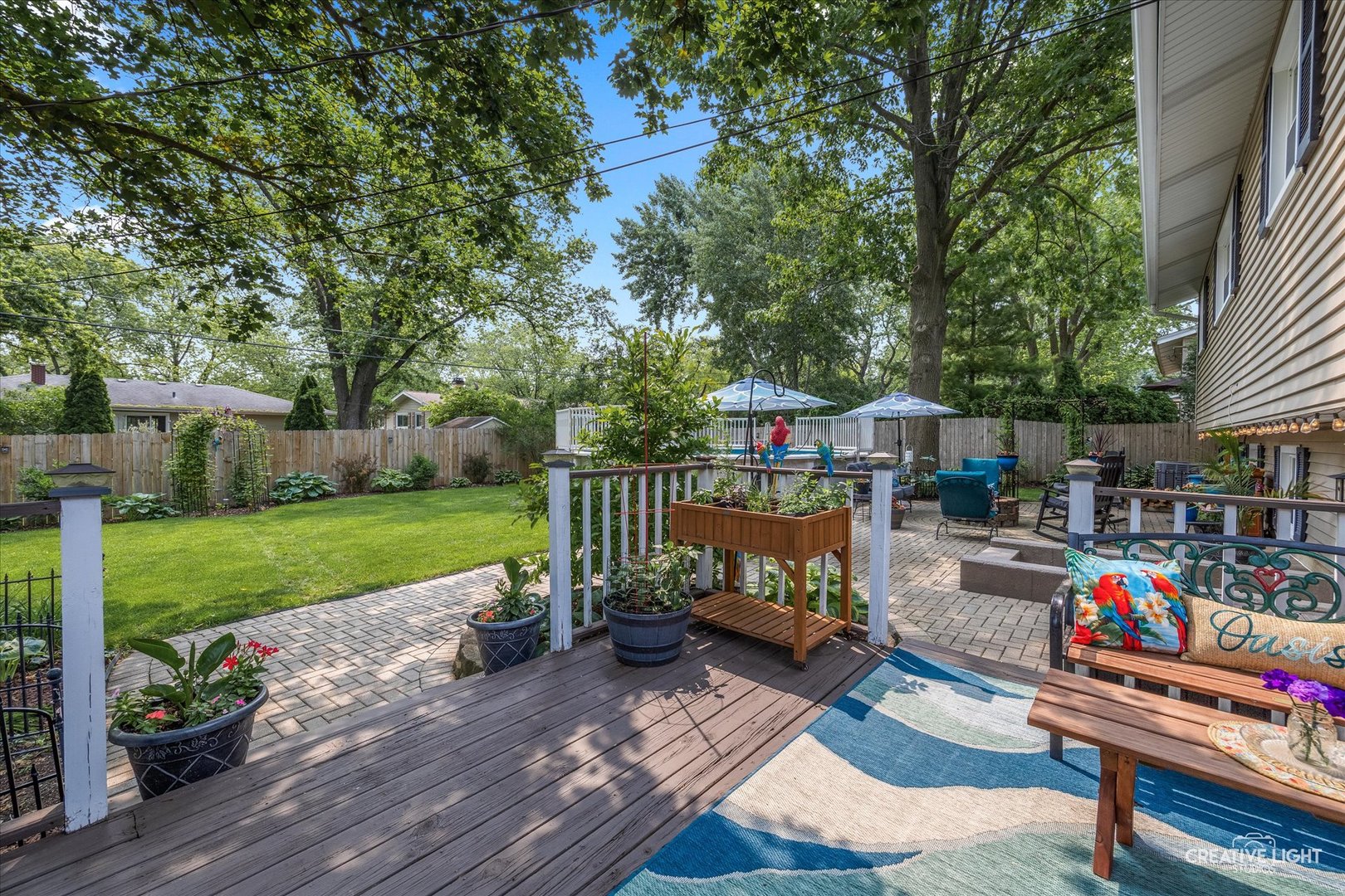 124 Fairview Drive St. Charles, IL 60174 - Photo 25 of 37 a view of a patio with couches table and chairs under an umbrella