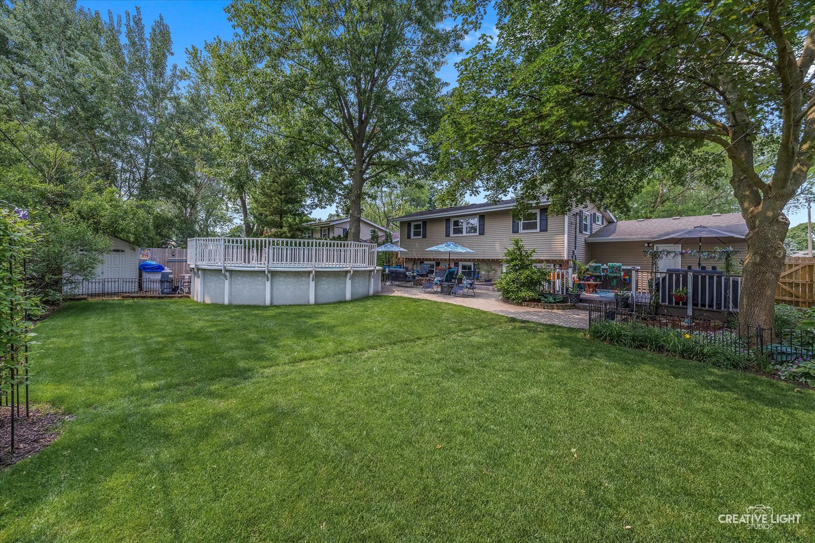 124 Fairview Drive St. Charles, IL 60174 - Photo 36 of 37 a view of a patio with table and chairs potted plants and large tree