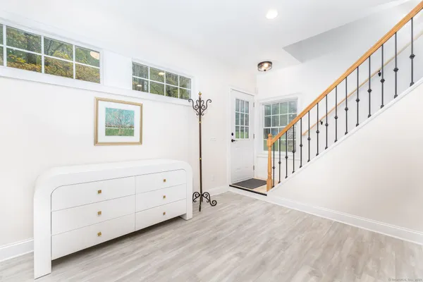 a view of an entryway with wooden floor