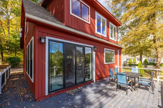 a view of a brick house with a chairs and table in a patio