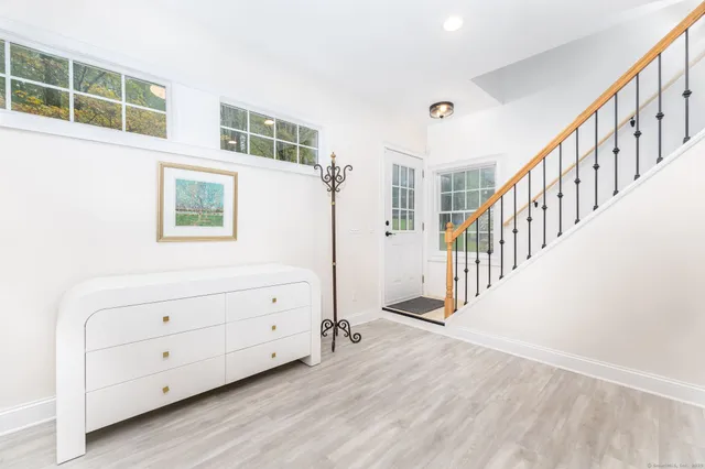 a view of an entryway with wooden floor