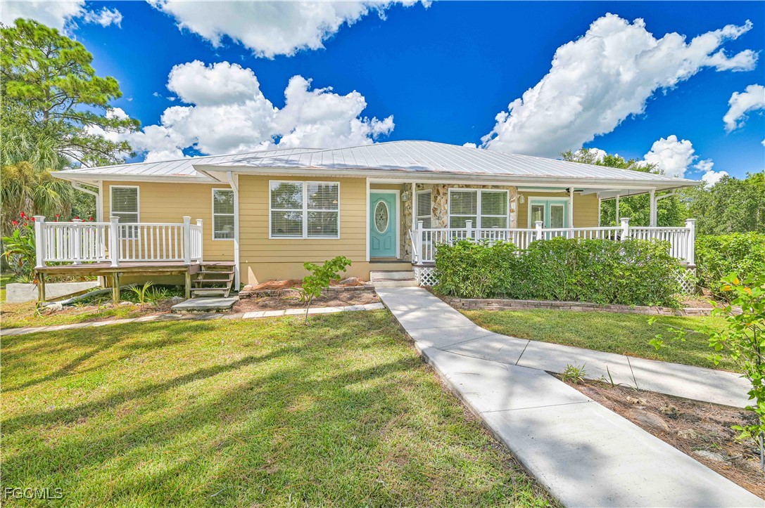 6840 Cadet Avenue Fort Myers, FL 33905 - Photo 1 of 37 a front view of a house with garden