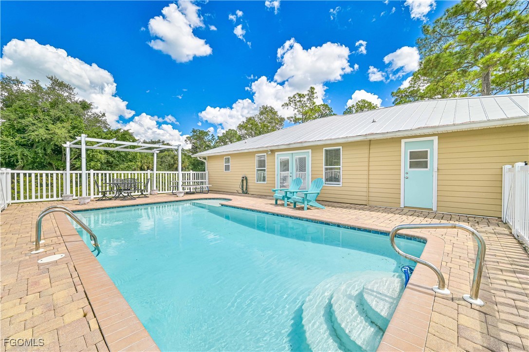 6840 Cadet Avenue Fort Myers, FL 33905 - Photo 11 of 37 a view of a house with swimming pool and a porch with furniture