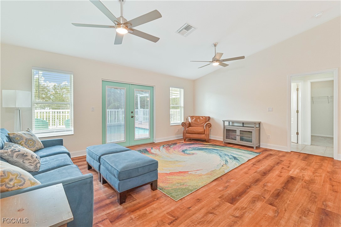 6840 Cadet Avenue Fort Myers, FL 33905 - Photo 17 of 37 a bedroom with a bed wooden floor and furniture
