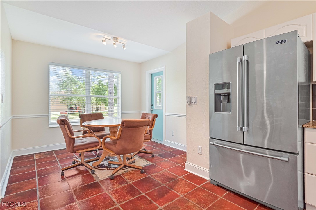 6840 Cadet Avenue Fort Myers, FL 33905 - Photo 23 of 37 a kitchen with stainless steel appliances granite countertop a refrigerator and a table