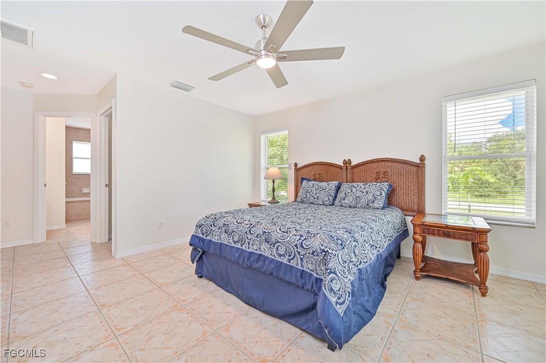 6840 Cadet Avenue Fort Myers, FL 33905 - Photo 26 of 37 a bedroom with a large bed and a window