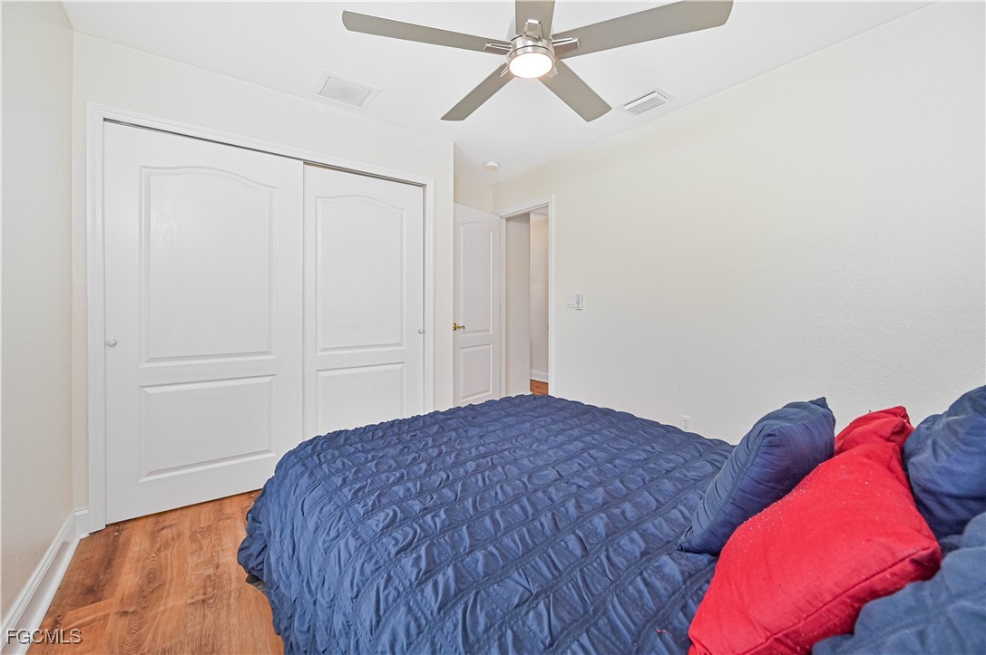 6840 Cadet Avenue Fort Myers, FL 33905 - Photo 32 of 37 a bedroom with a bed and a chandelier