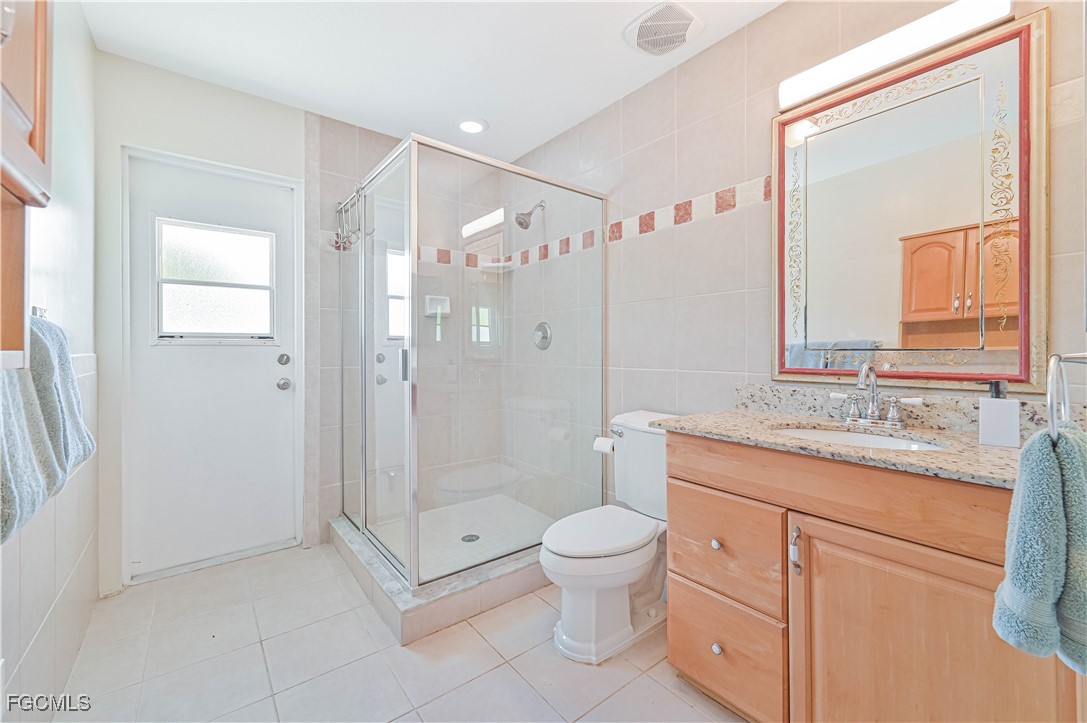 6840 Cadet Avenue Fort Myers, FL 33905 - Photo 33 of 37 a bathroom with a granite countertop sink a toilet and shower