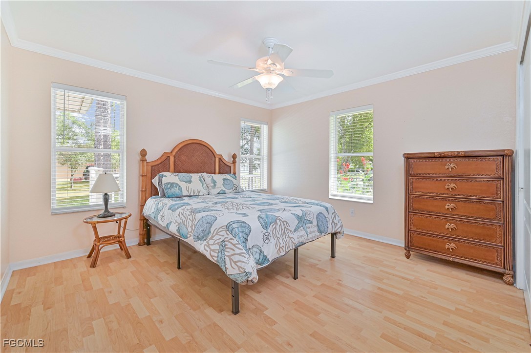 6840 Cadet Avenue Fort Myers, FL 33905 - Photo 34 of 37 a bedroom with a bed and a dresser