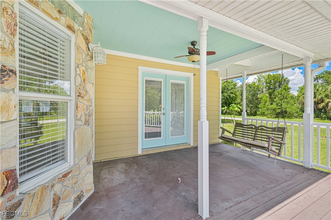 6840 Cadet Avenue Fort Myers, FL 33905 - Photo 5 of 37 a view of a porch with wooden floor and roof