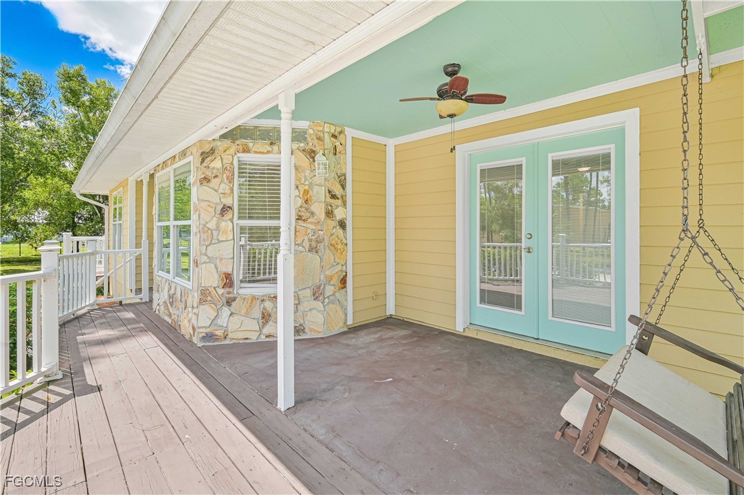6840 Cadet Avenue Fort Myers, FL 33905 - Photo 6 of 37 a view of a porch with wooden floor and deck