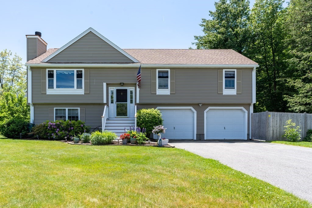 32 Beach Road Salisbury, MA 01952 - Photo 1 of 36 a front view of a house with a yard and garage