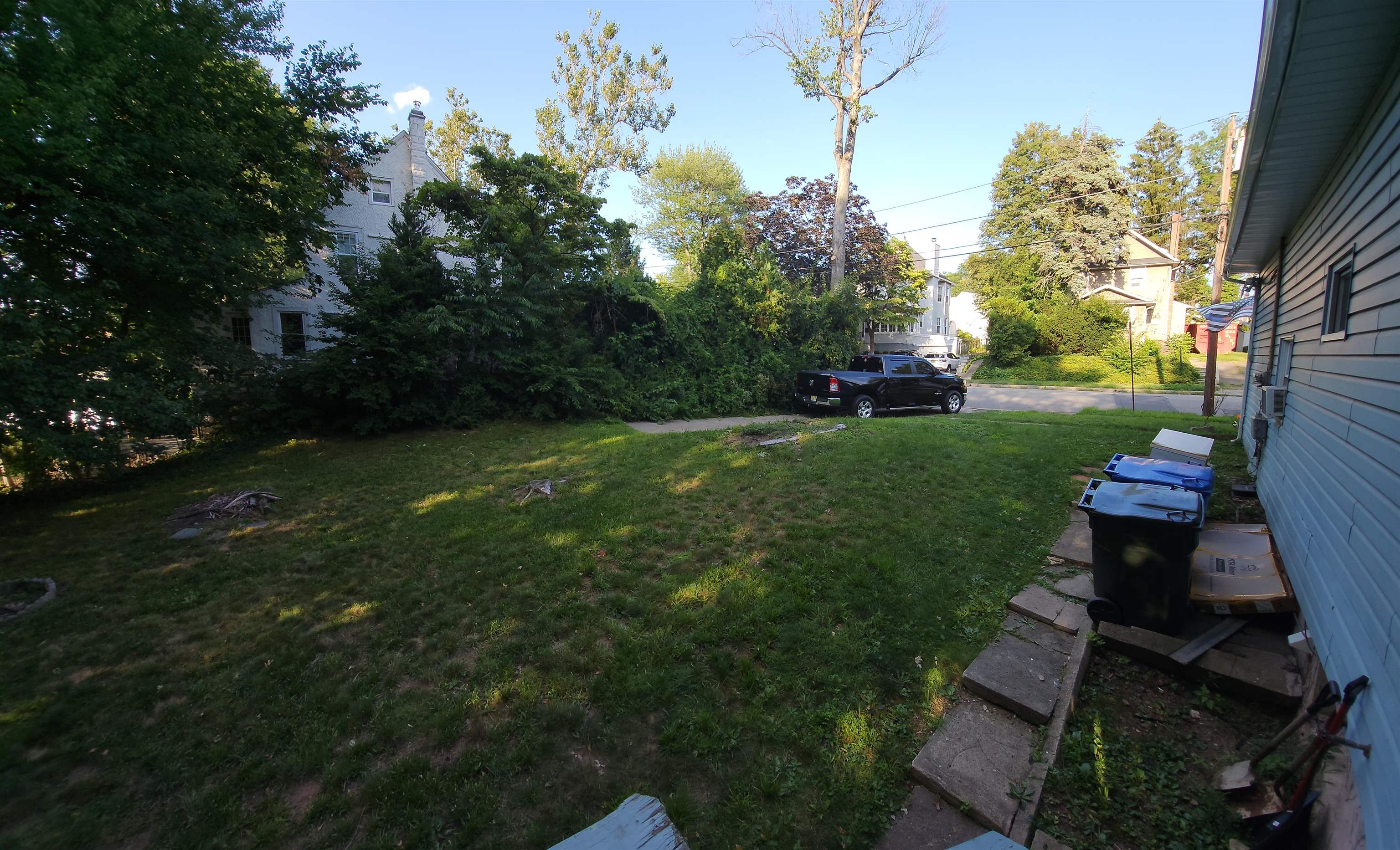 520 Stuyvesant Avenue Rutherford, NJ 07070 - Photo 8 of 9 a backyard of a house with table and chairs plants and large trees