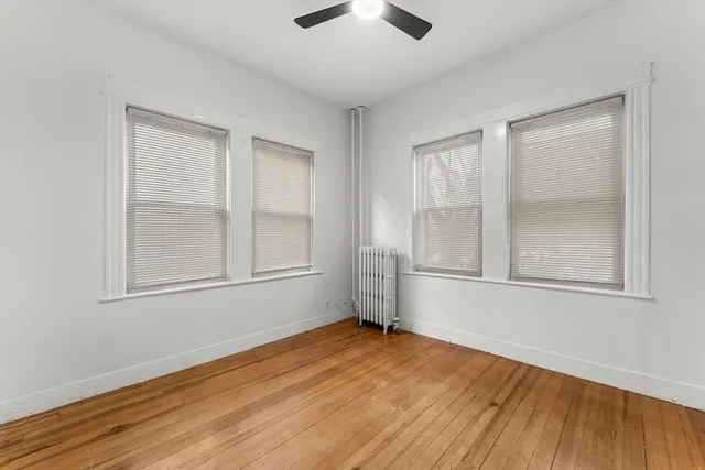 a view of a room with wooden floor and window