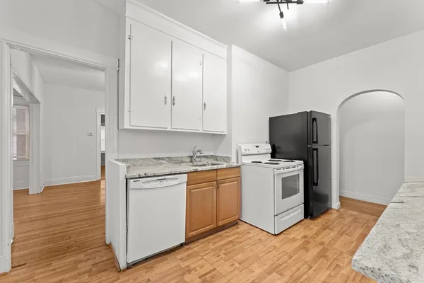 a view of a kitchen with white cabinets