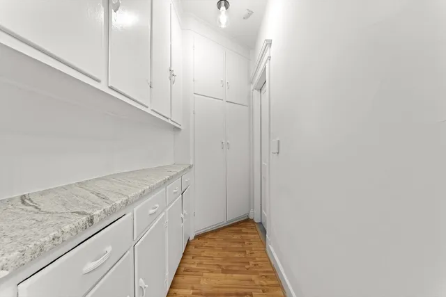 a view of a room with wooden floor and white walls