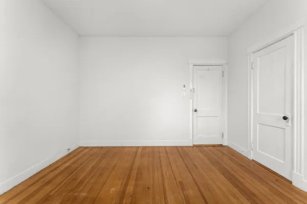 a view of a room with wooden floor